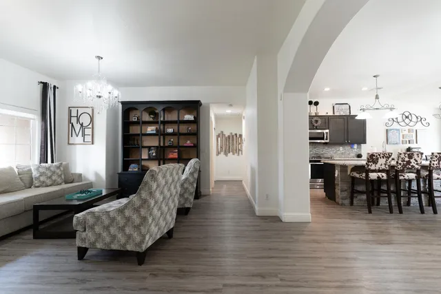 a living room with furniture and wooden floor