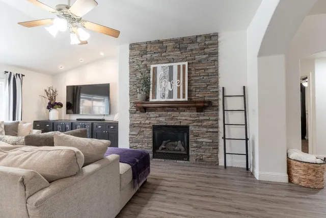 a living room with furniture a fireplace and a flat screen tv