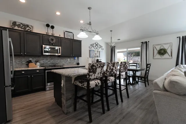 a kitchen with stainless steel appliances a sink stove and refrigerator