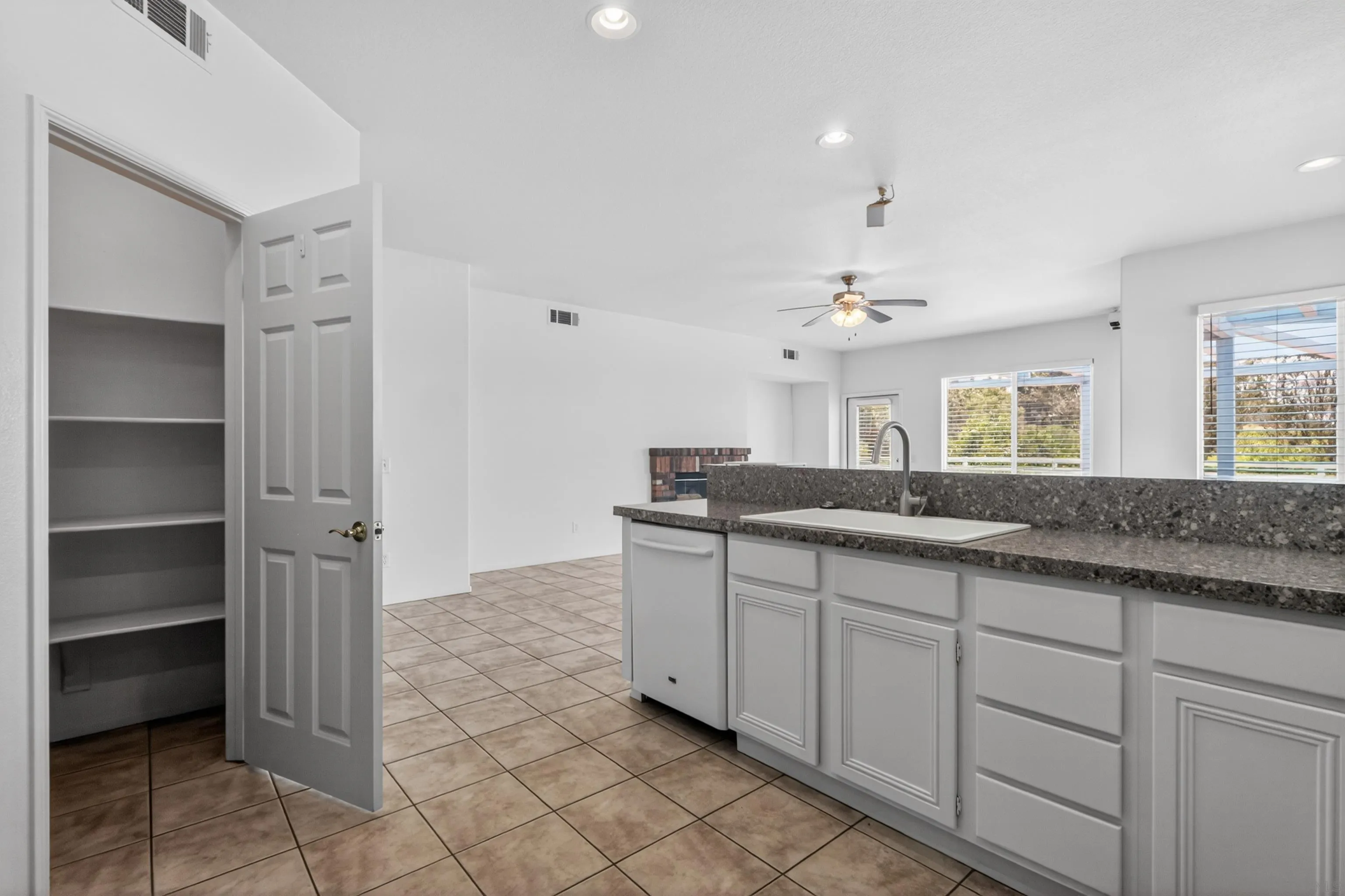 1432 Belmont Park Road Oceanside, CA 92057 - Photo 21 of 54 a bathroom with a granite countertop sink and a mirror