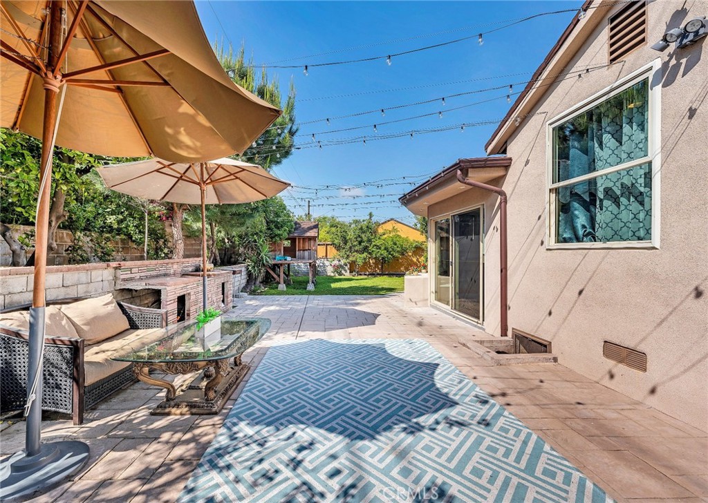 818 Bethany Road Burbank, CA 91504 - Photo 2 of 23 a view of a patio with a table and chairs under an umbrella