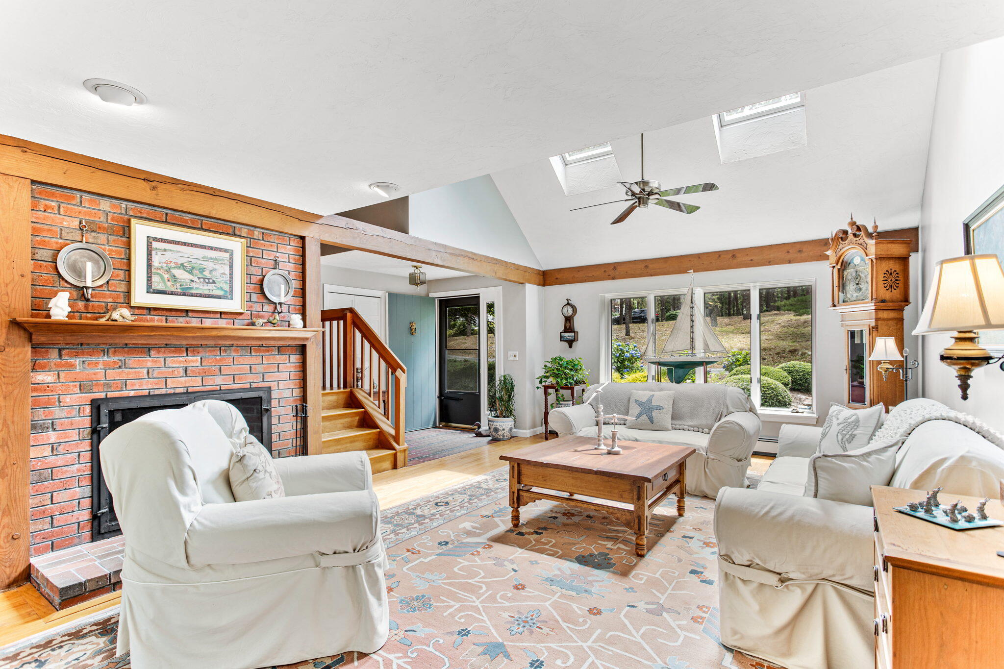 40 Point Isabella Road Cotuit, MA 02635 - Photo 13 of 28 a living room with furniture a fireplace and a large window