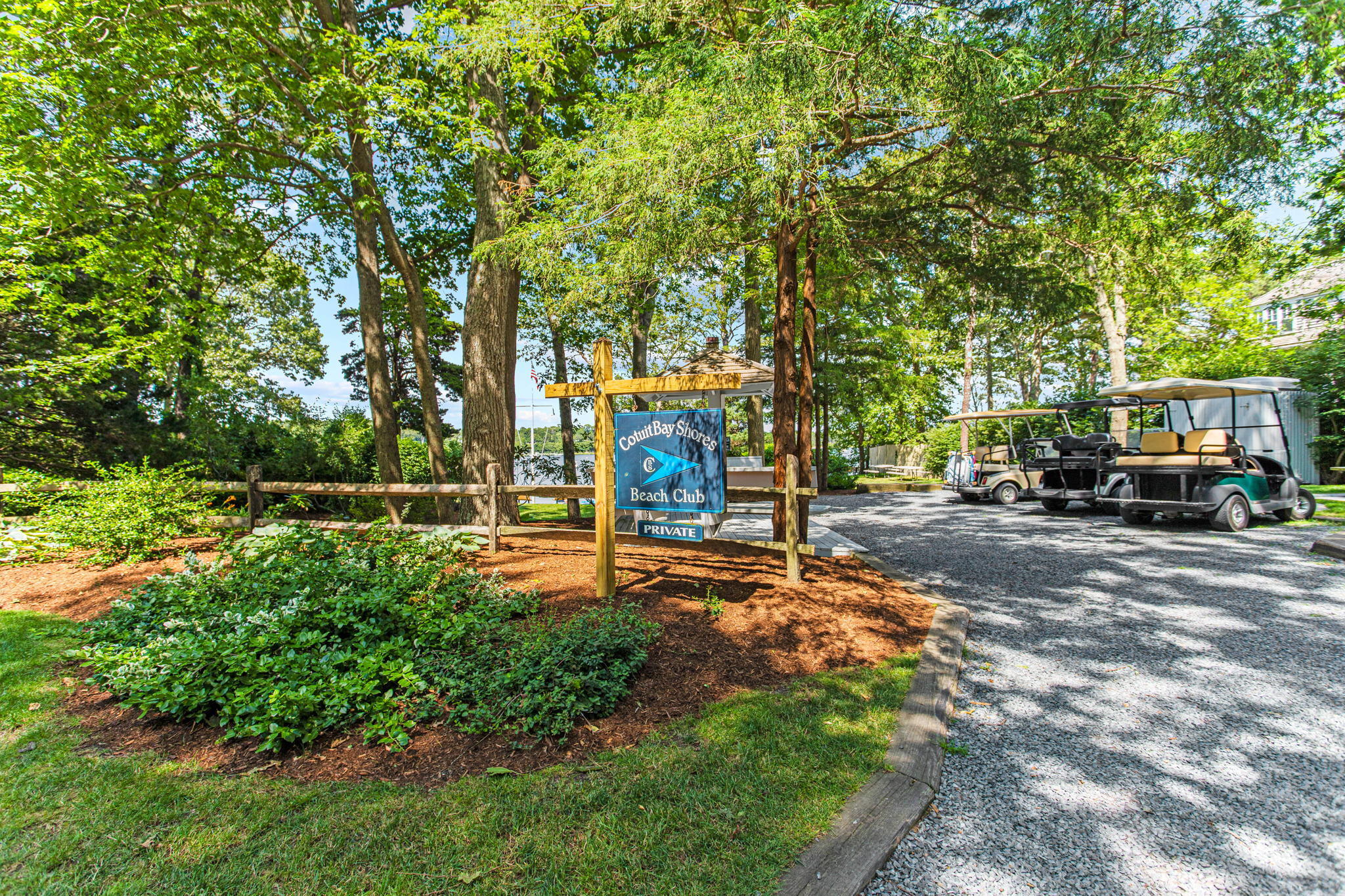 40 Point Isabella Road Cotuit, MA 02635 - Photo 26 of 28 a view of a park that has large trees and a parked car