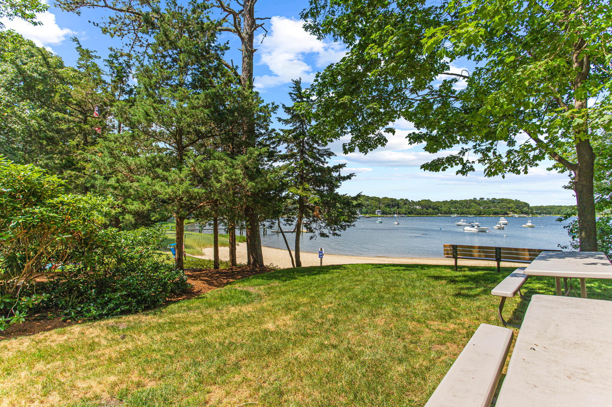 40 Point Isabella Road Cotuit, MA 02635 - Photo 27 of 28 a view of a lake with a house in the background