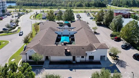 an aerial view of a house with outdoor space and lake view