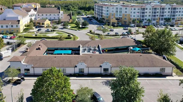 an aerial view of multiple houses with yard