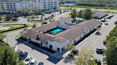 an aerial view of a house with outdoor space and lake view in back