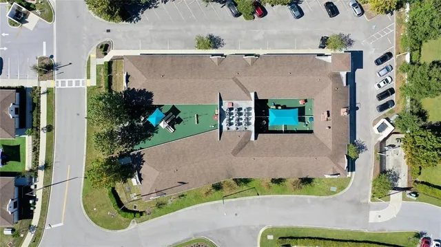 an aerial view of a house with a yard and potted plants