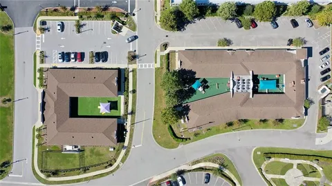 an aerial view of a house with a swimming pool