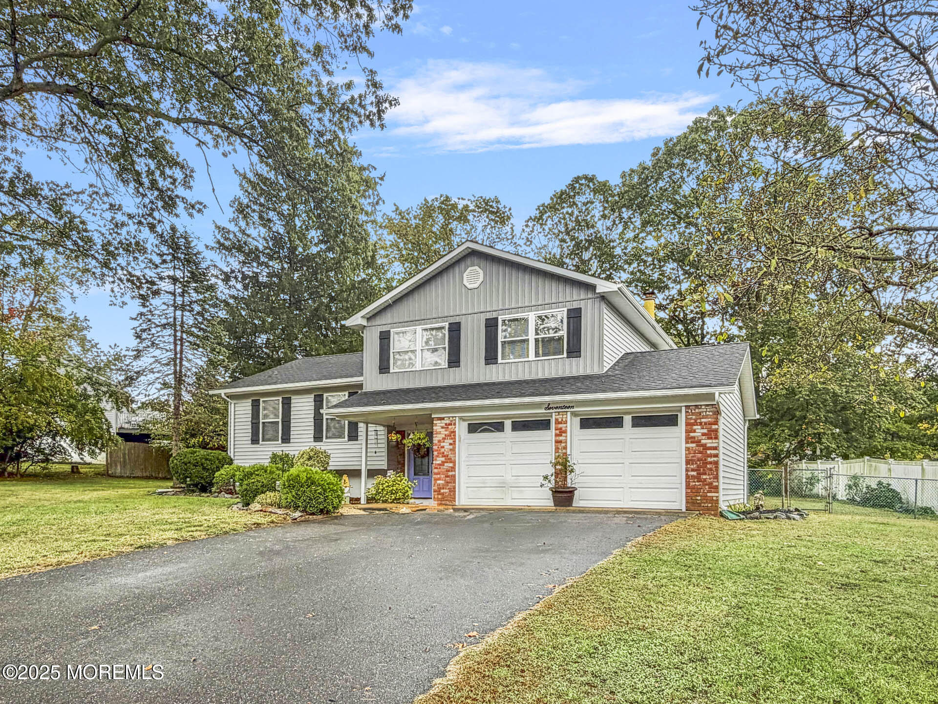 17 North Longview Road Howell, NJ 07731 - Photo 2 of 30 a front view of a house with a garden and trees