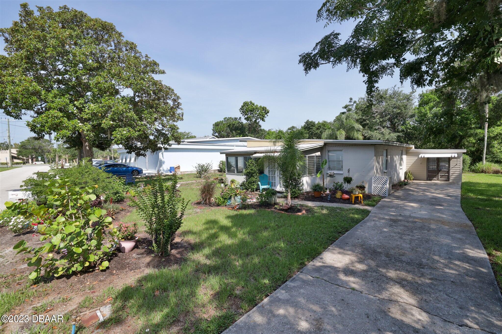 113 Evergreen Avenue Edgewater, FL 32132 - Photo 1 of 47 a front view of a house with garden