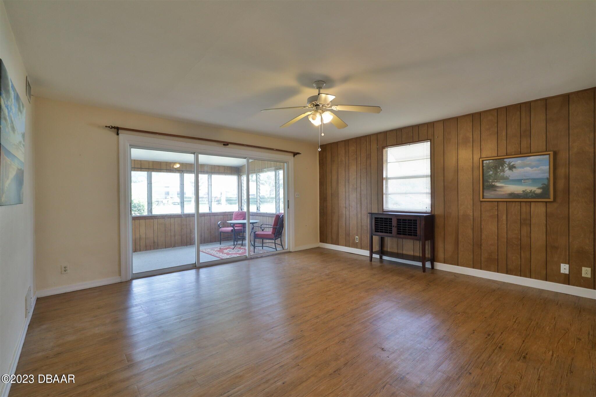 113 Evergreen Avenue Edgewater, FL 32132 - Photo 11 of 47 wooden floor in an empty room with a window