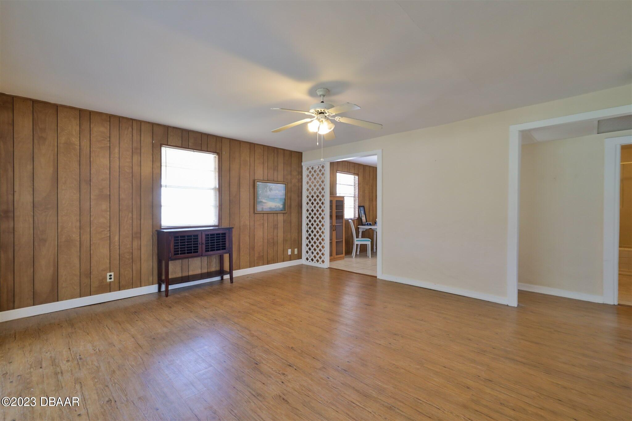 113 Evergreen Avenue Edgewater, FL 32132 - Photo 14 of 47 a view of an empty room with a window and wooden floor