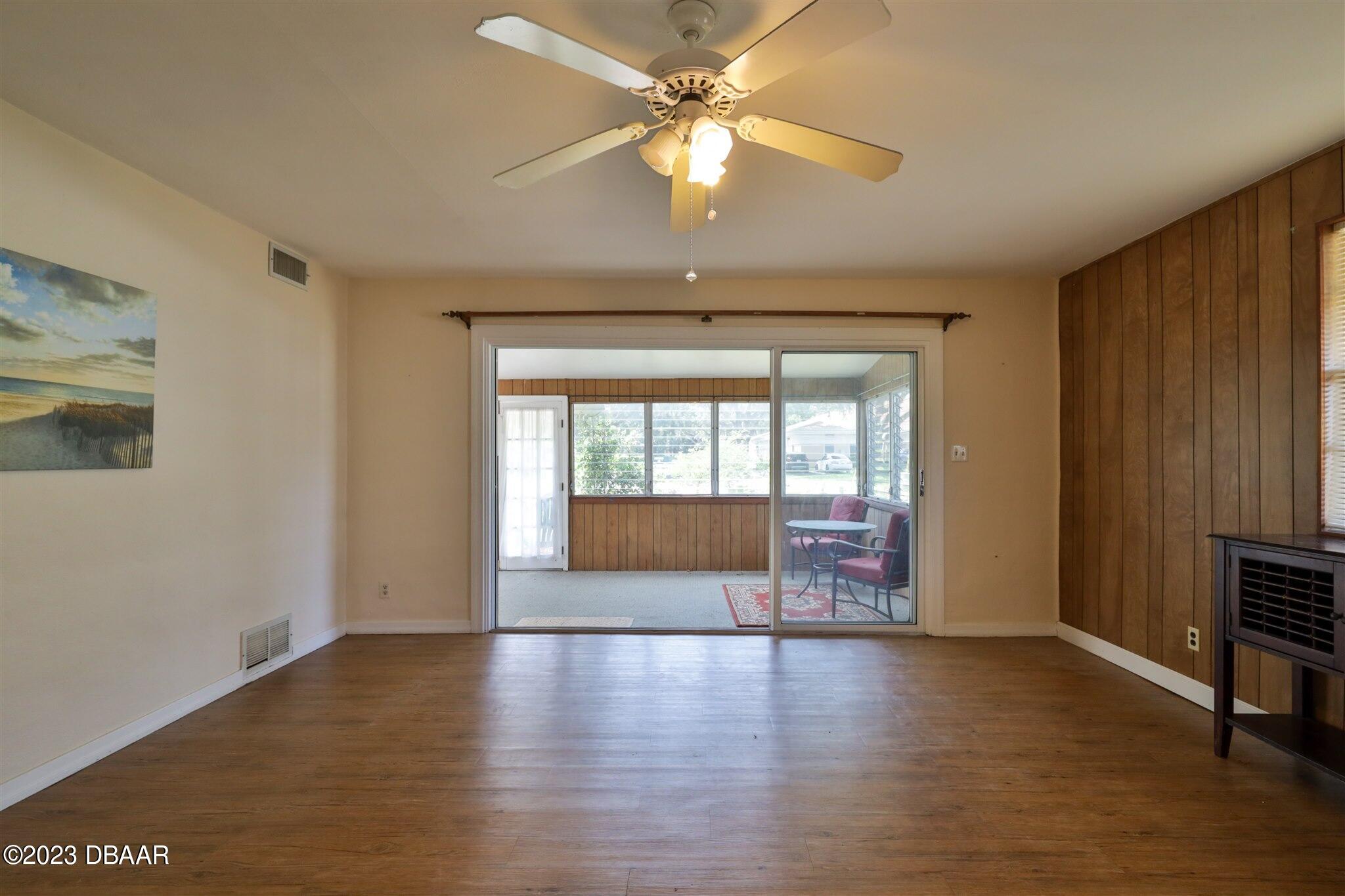 113 Evergreen Avenue Edgewater, FL 32132 - Photo 17 of 47 wooden floor in an empty room with a window
