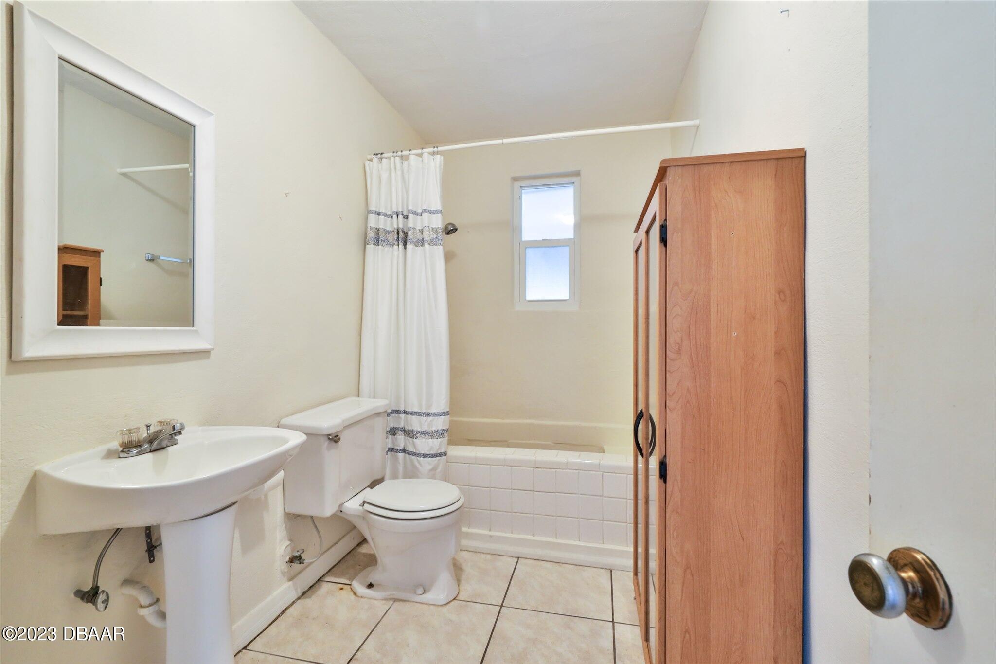 113 Evergreen Avenue Edgewater, FL 32132 - Photo 20 of 47 a bathroom with a toilet a sink and shower