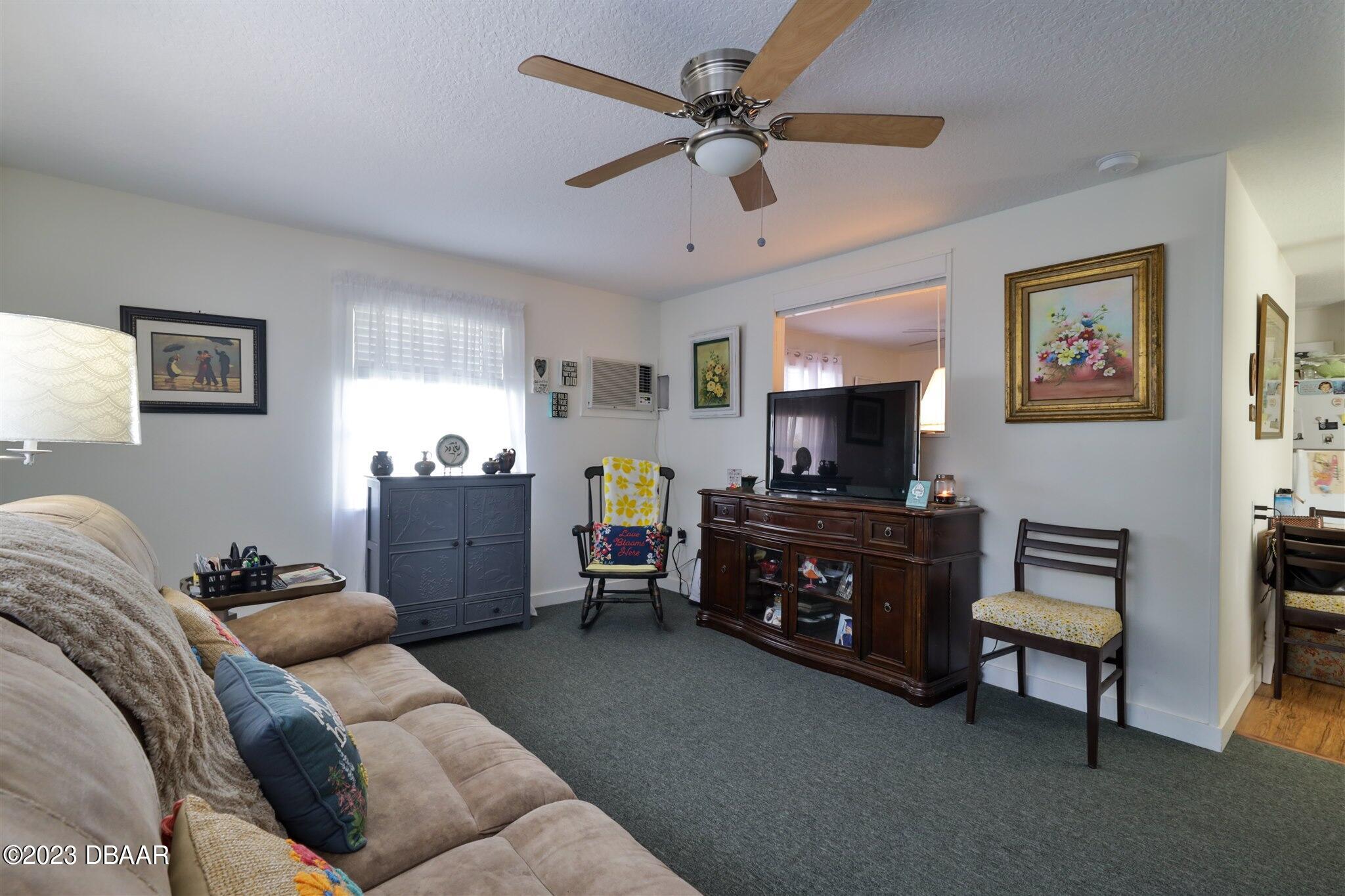 113 Evergreen Avenue Edgewater, FL 32132 - Photo 25 of 47 a living room with furniture and a flat screen tv