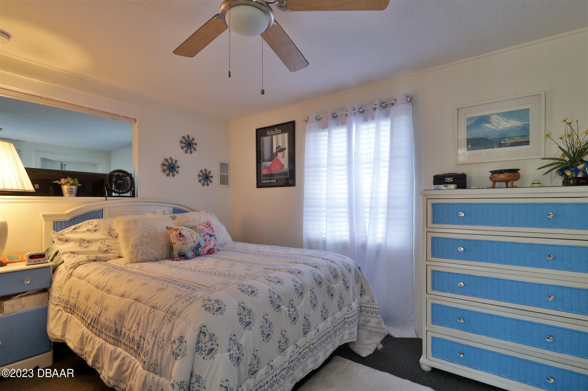 113 Evergreen Avenue Edgewater, FL 32132 - Photo 27 of 47 a bedroom with a bed and wooden floor