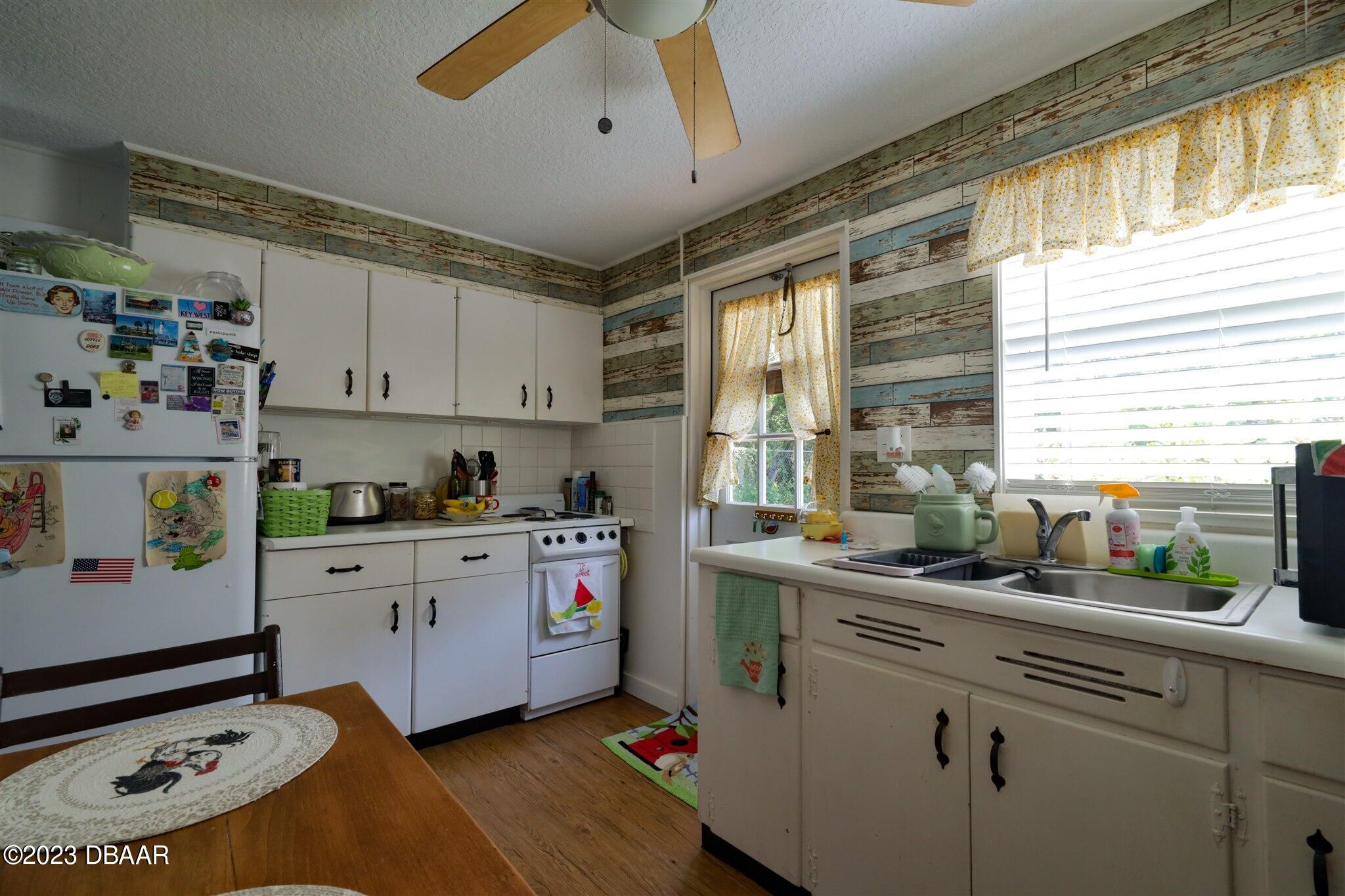 113 Evergreen Avenue Edgewater, FL 32132 - Photo 30 of 47 a kitchen with a sink appliances cabinets and a window
