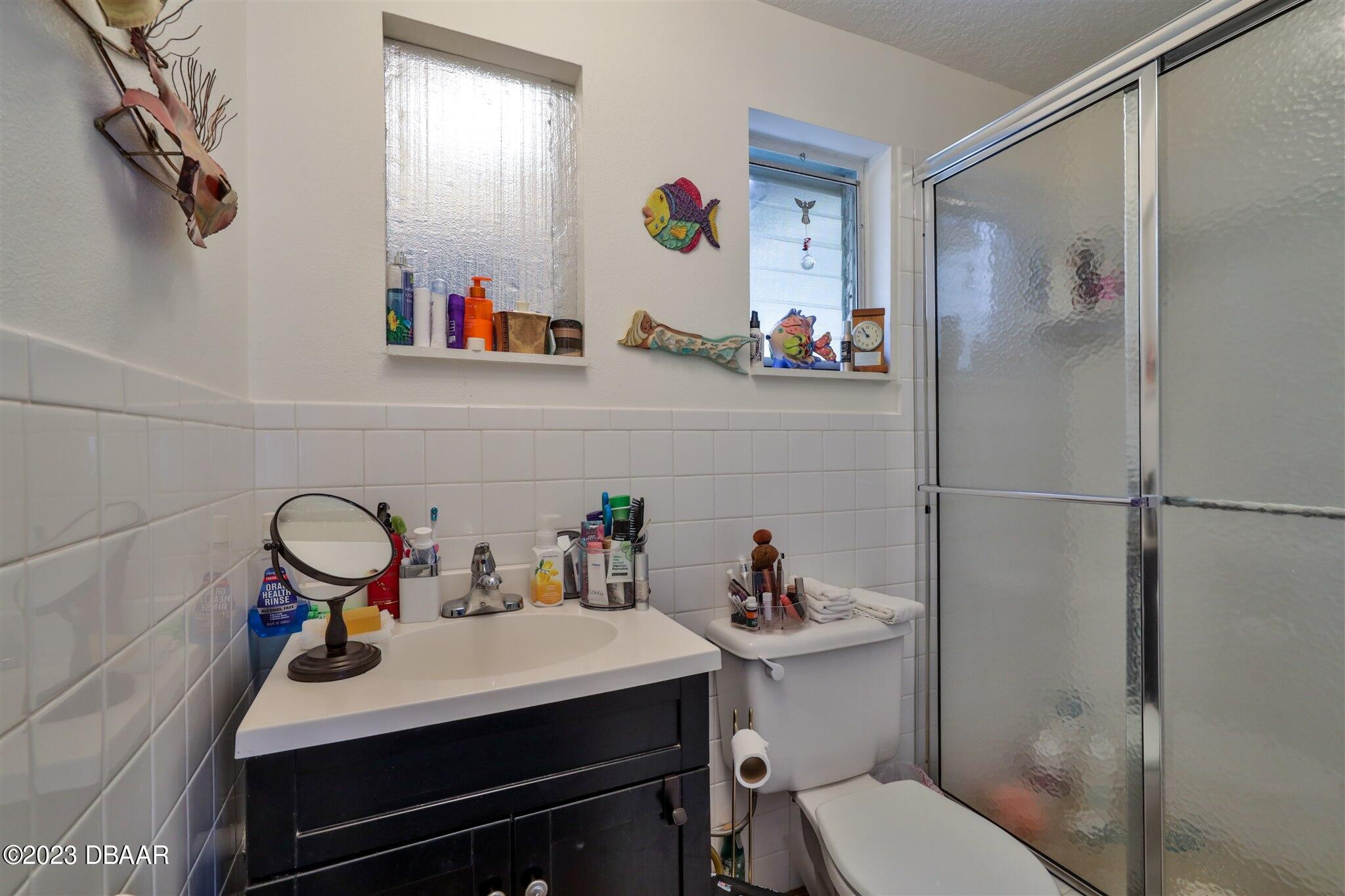 113 Evergreen Avenue Edgewater, FL 32132 - Photo 31 of 47 a bathroom with a sink mirror toilet and vanity