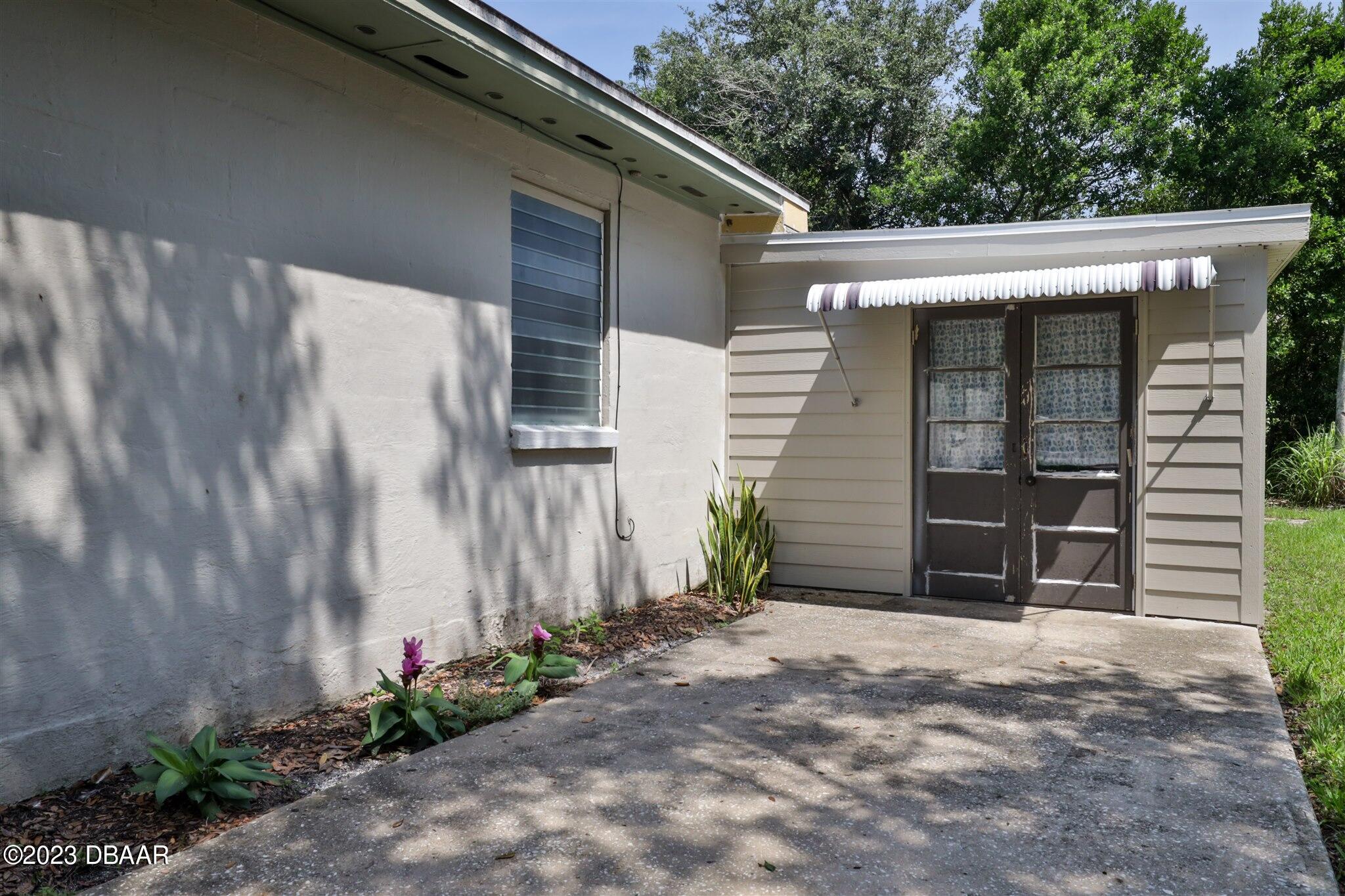 113 Evergreen Avenue Edgewater, FL 32132 - Photo 32 of 47 a front view of a house with a yard