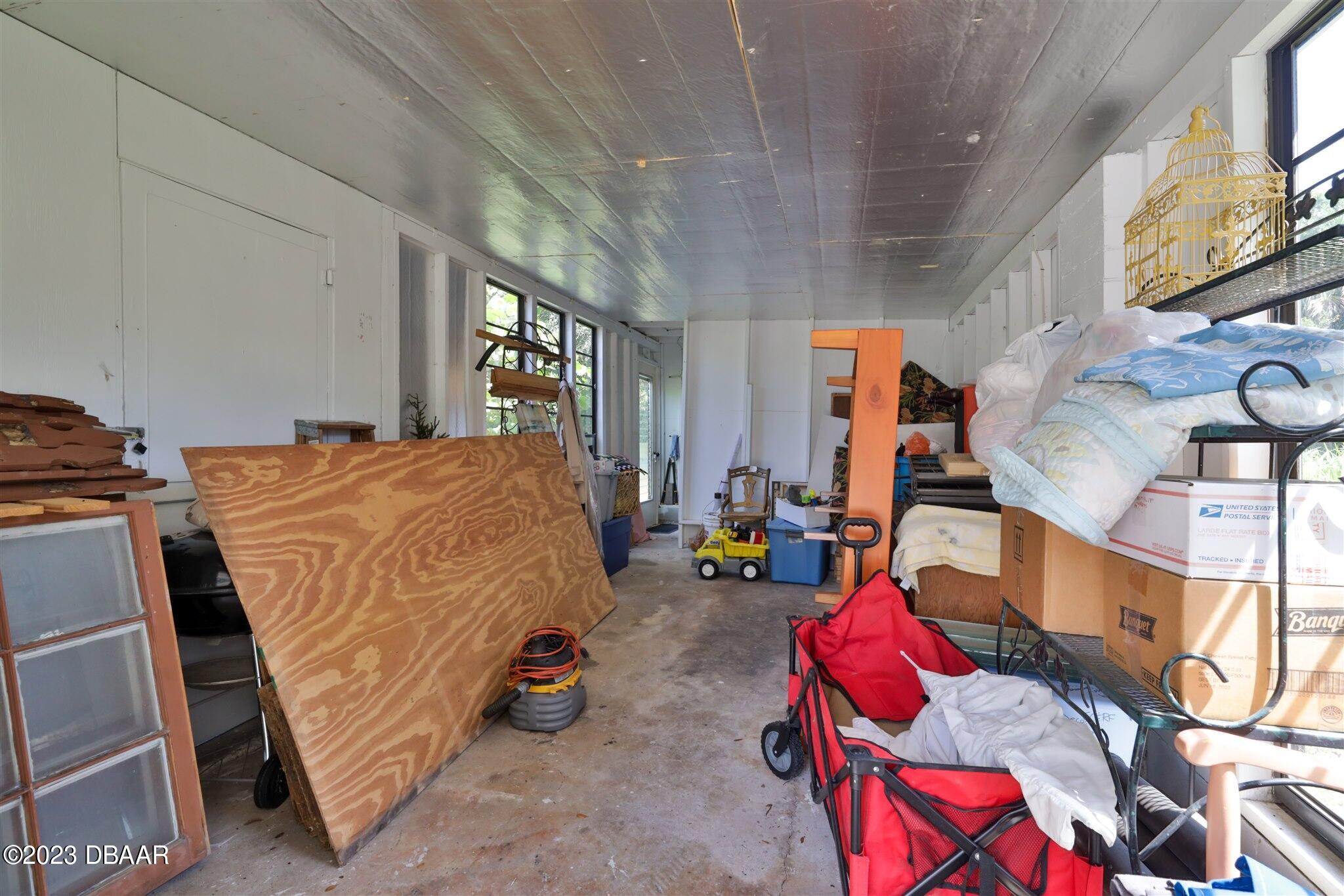 113 Evergreen Avenue Edgewater, FL 32132 - Photo 34 of 47 a bedroom with furniture and a flat screen tv