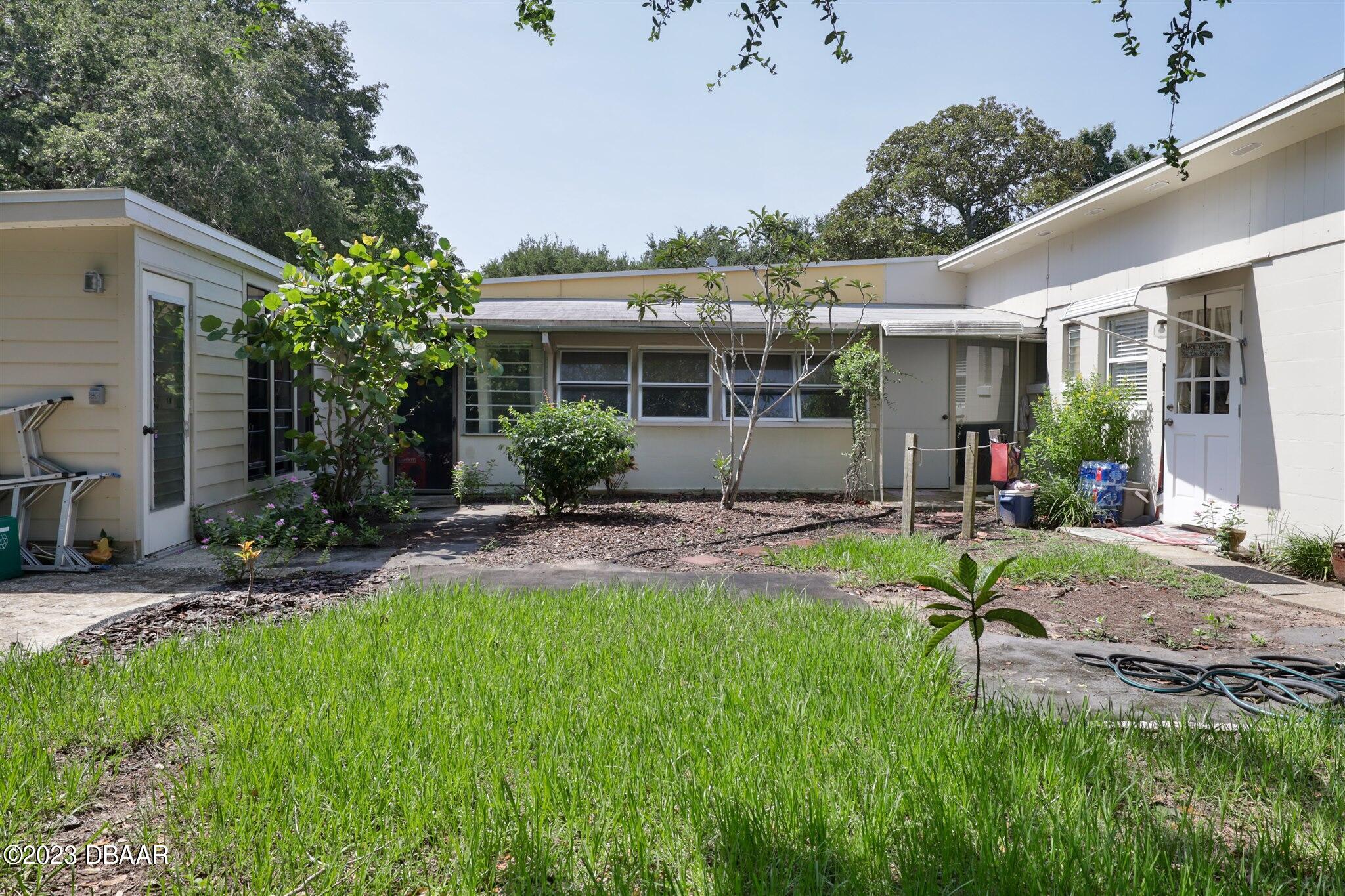 113 Evergreen Avenue Edgewater, FL 32132 - Photo 38 of 47 a view of a house with backyard and a patio