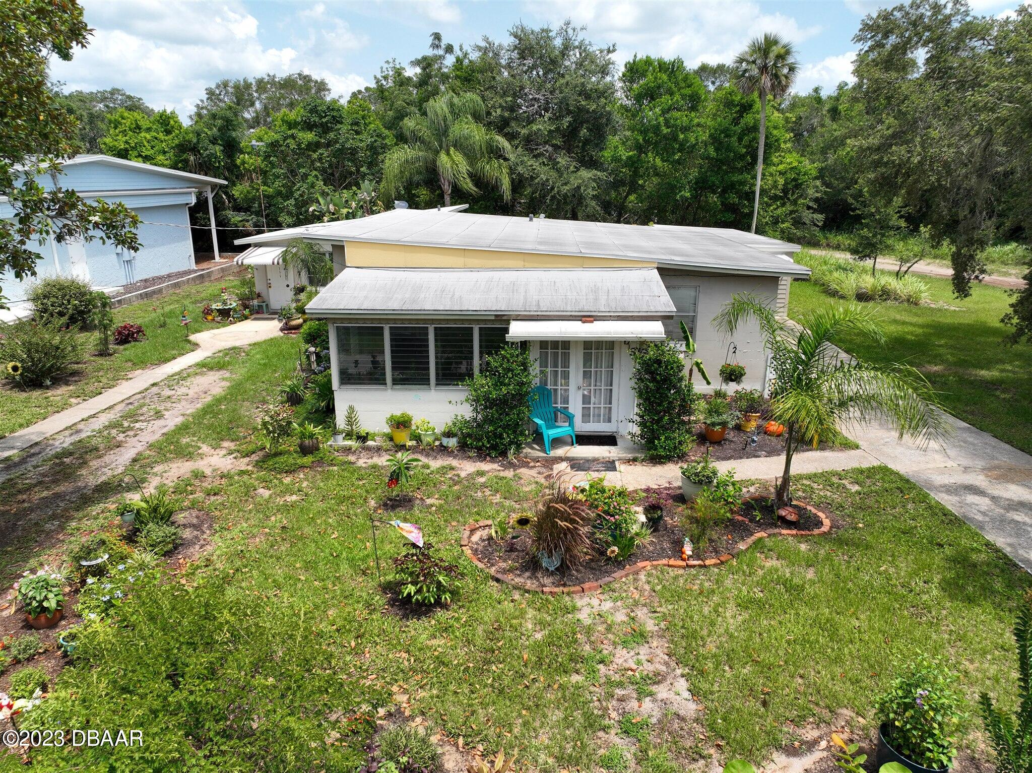 113 Evergreen Avenue Edgewater, FL 32132 - Photo 42 of 47 a view of a house with backyard and sitting area