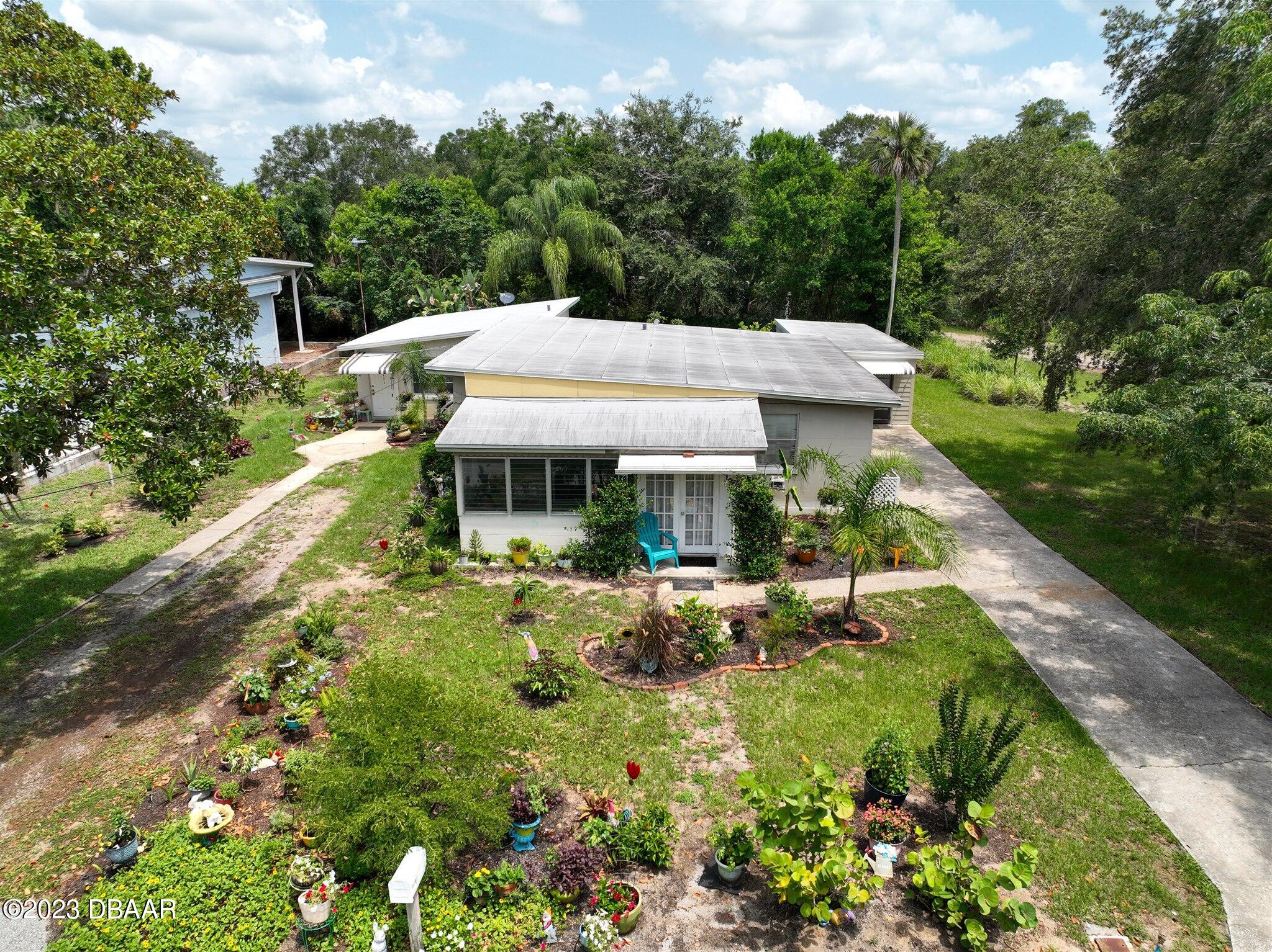 113 Evergreen Avenue Edgewater, FL 32132 - Photo 43 of 47 a aerial view of a house with swimming pool garden view and trees