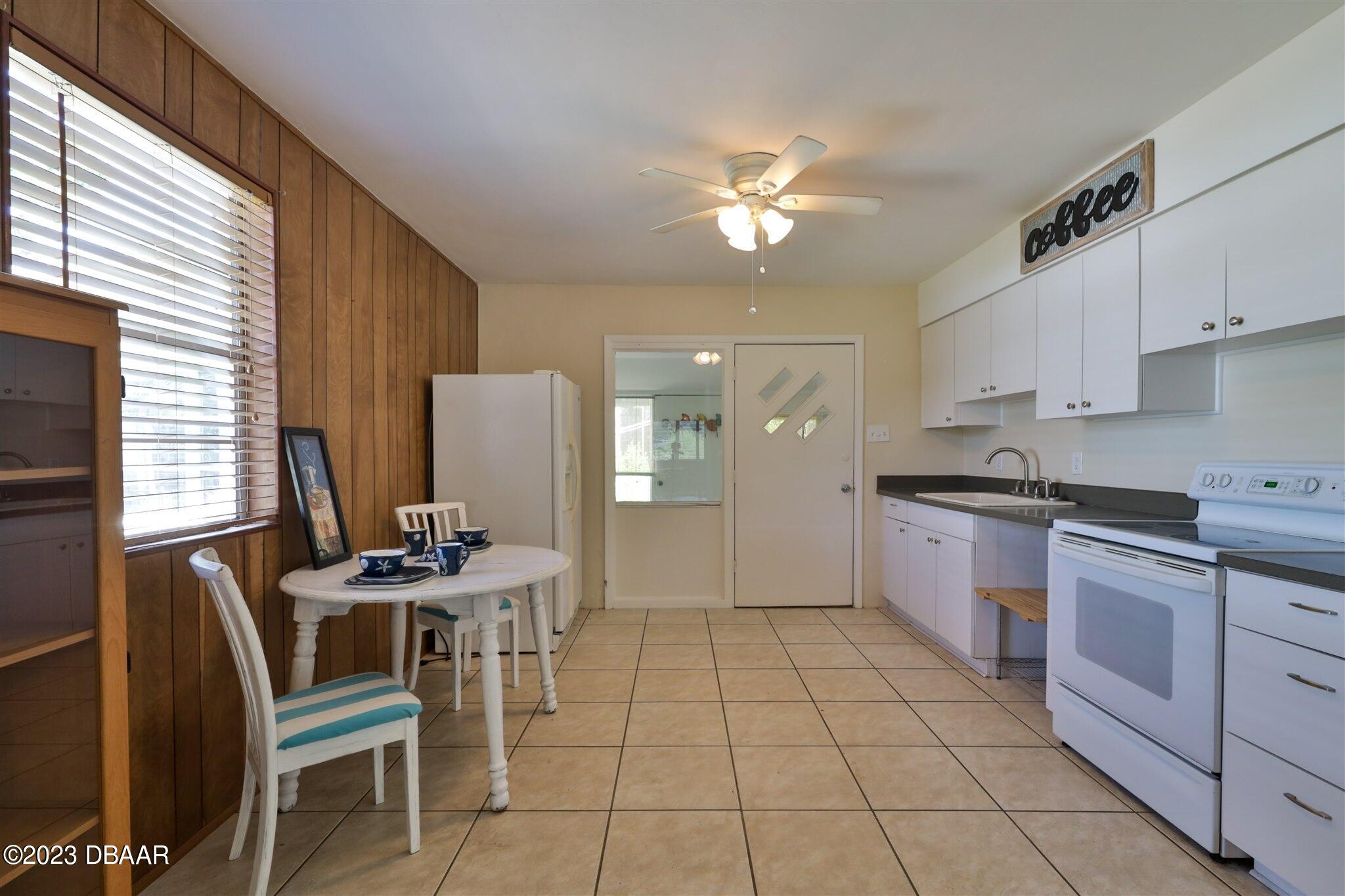 113 Evergreen Avenue Edgewater, FL 32132 - Photo 6 of 47 a kitchen with a dining table cabinets and appliances