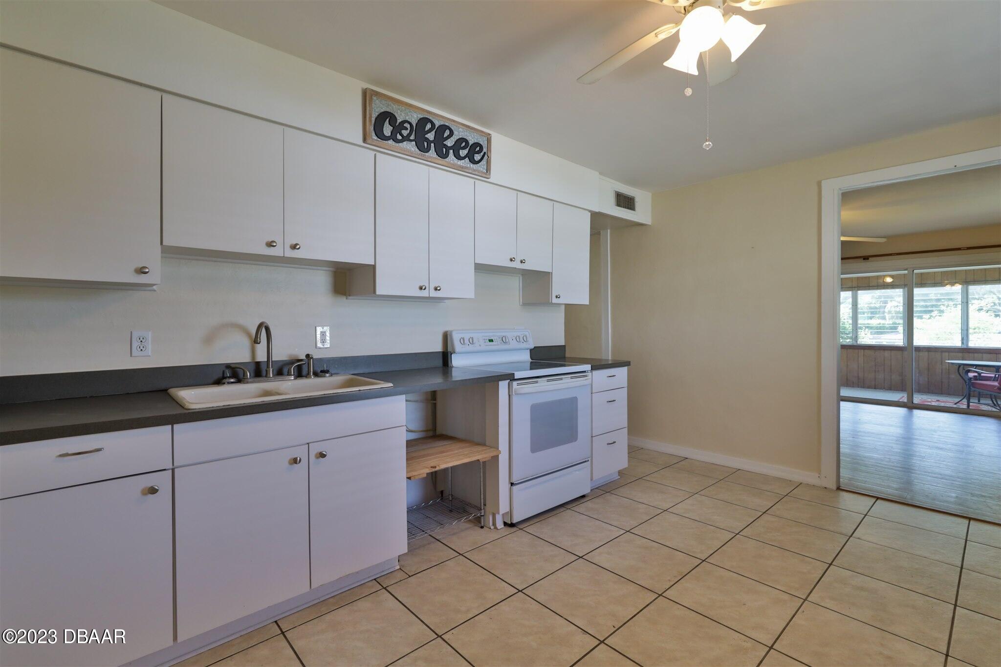 113 Evergreen Avenue Edgewater, FL 32132 - Photo 7 of 47 a kitchen with stainless steel appliances granite countertop a sink and cabinets