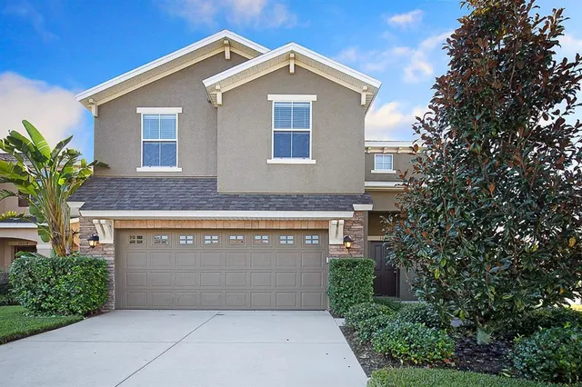 a front view of a house with a yard and garage