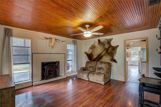 a kitchen with granite countertop a stove cabinets and wooden floor