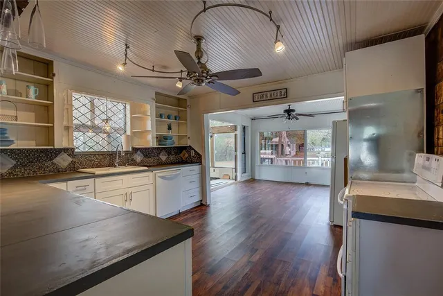a bathroom with a granite countertop sink toilet a mirror and shower