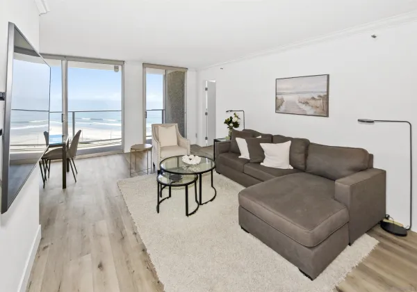 a living room with furniture wooden floor and a table