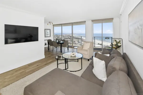 a living room with furniture a flat screen tv and a floor to ceiling window
