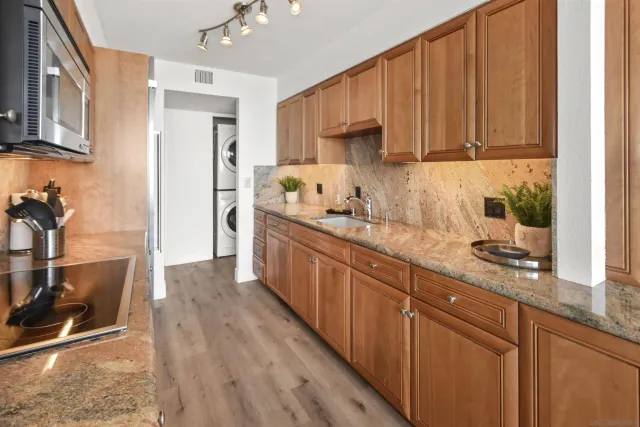 a kitchen with stainless steel appliances wooden cabinets a sink and a stove