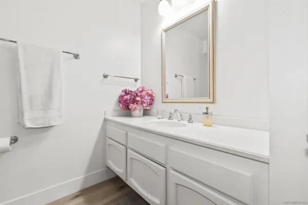 a bathroom with a sink vanity and mirror