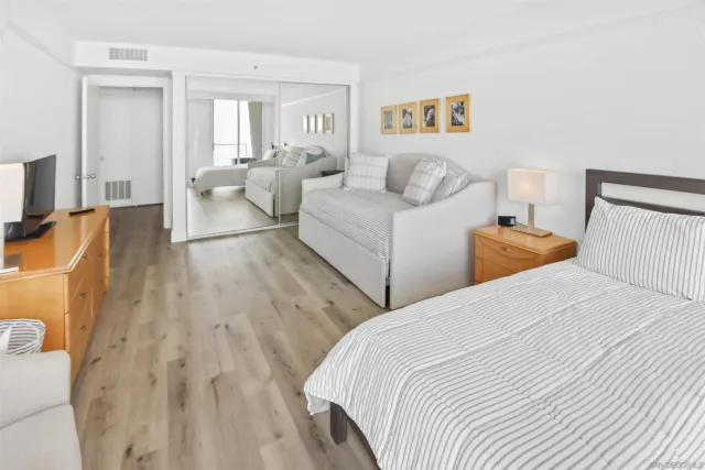 a bedroom with two beds and a couch