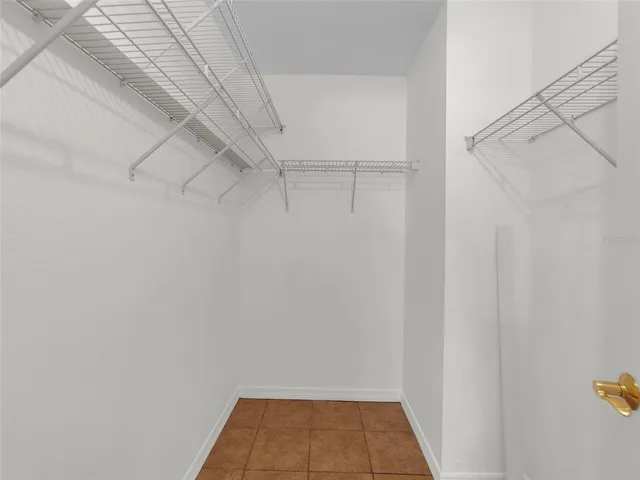 an empty room with windows and ceiling fan