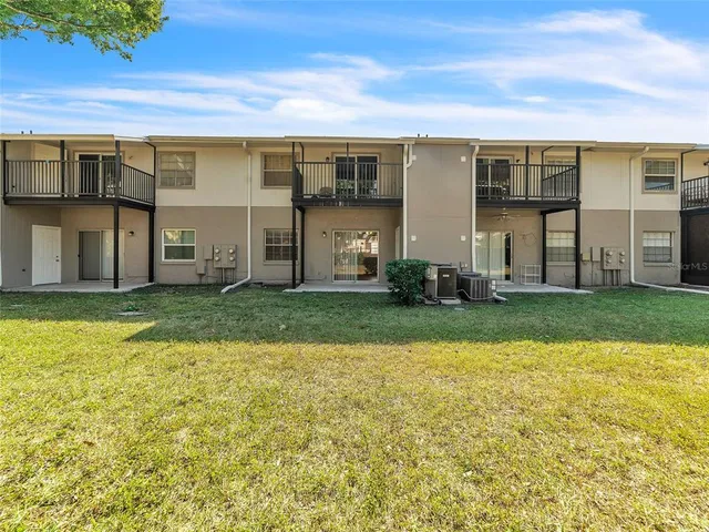 a view of a house with a yard and sitting area
