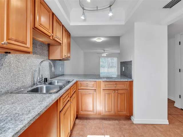 a kitchen with stainless steel appliances granite countertop a stove and cabinets
