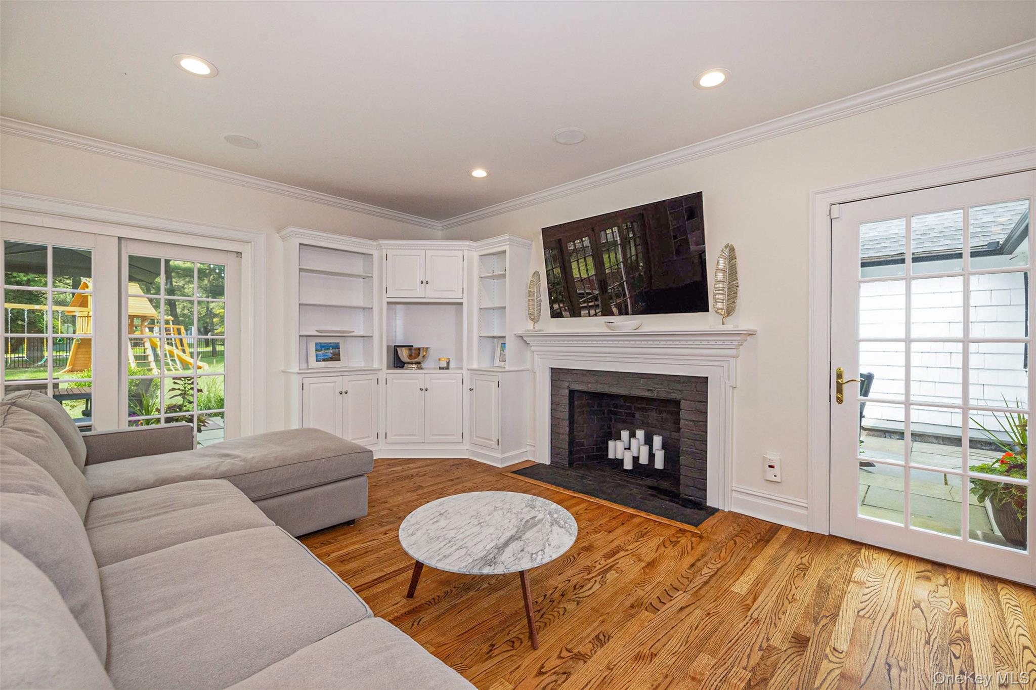 18 Lakeside Drive Rye, NY 10580 - Photo 18 of 43 a living room with furniture a fireplace and a flat screen tv