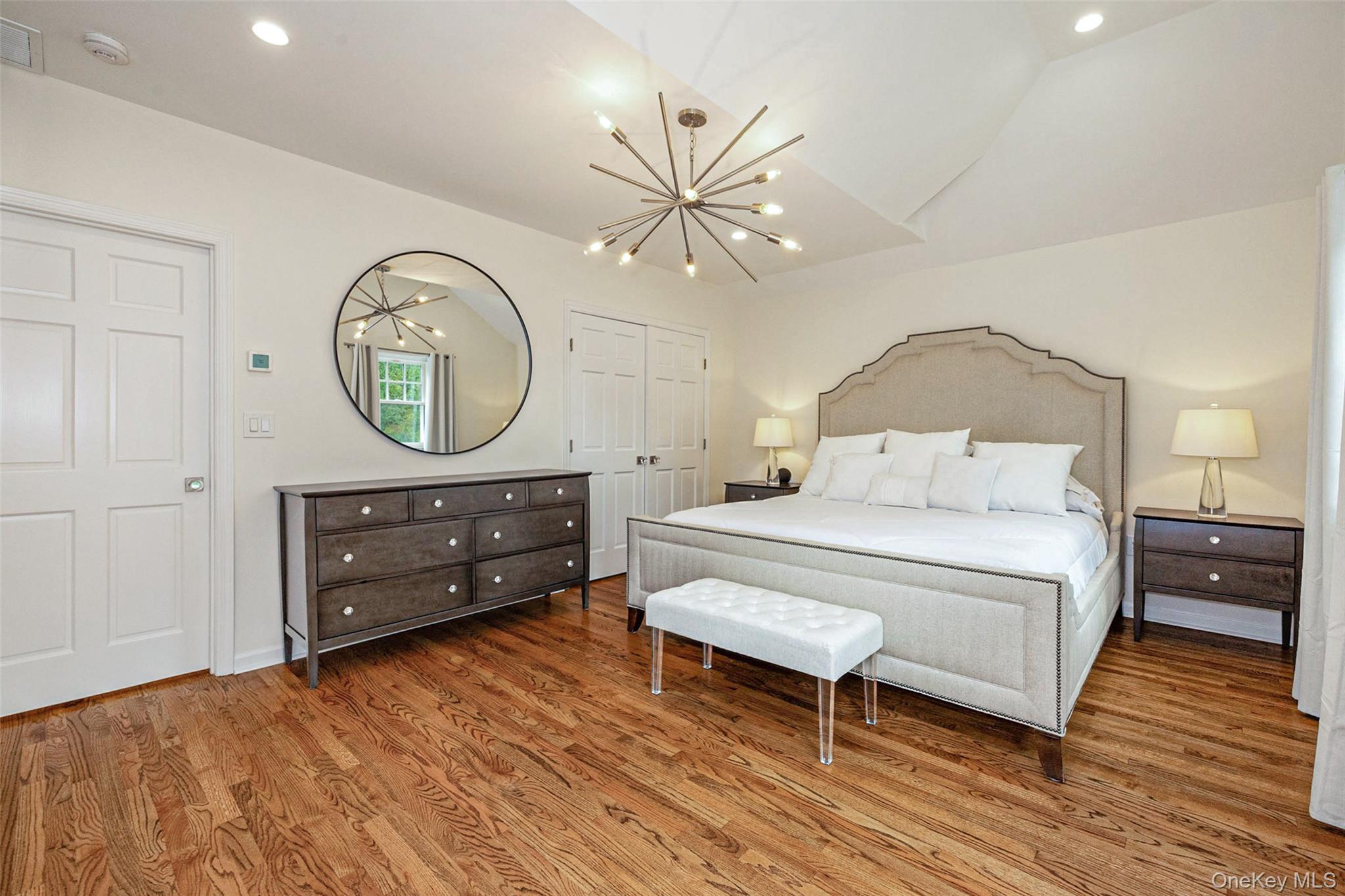 18 Lakeside Drive Rye, NY 10580 - Photo 22 of 43 a bedroom with a bed a mirror and a table