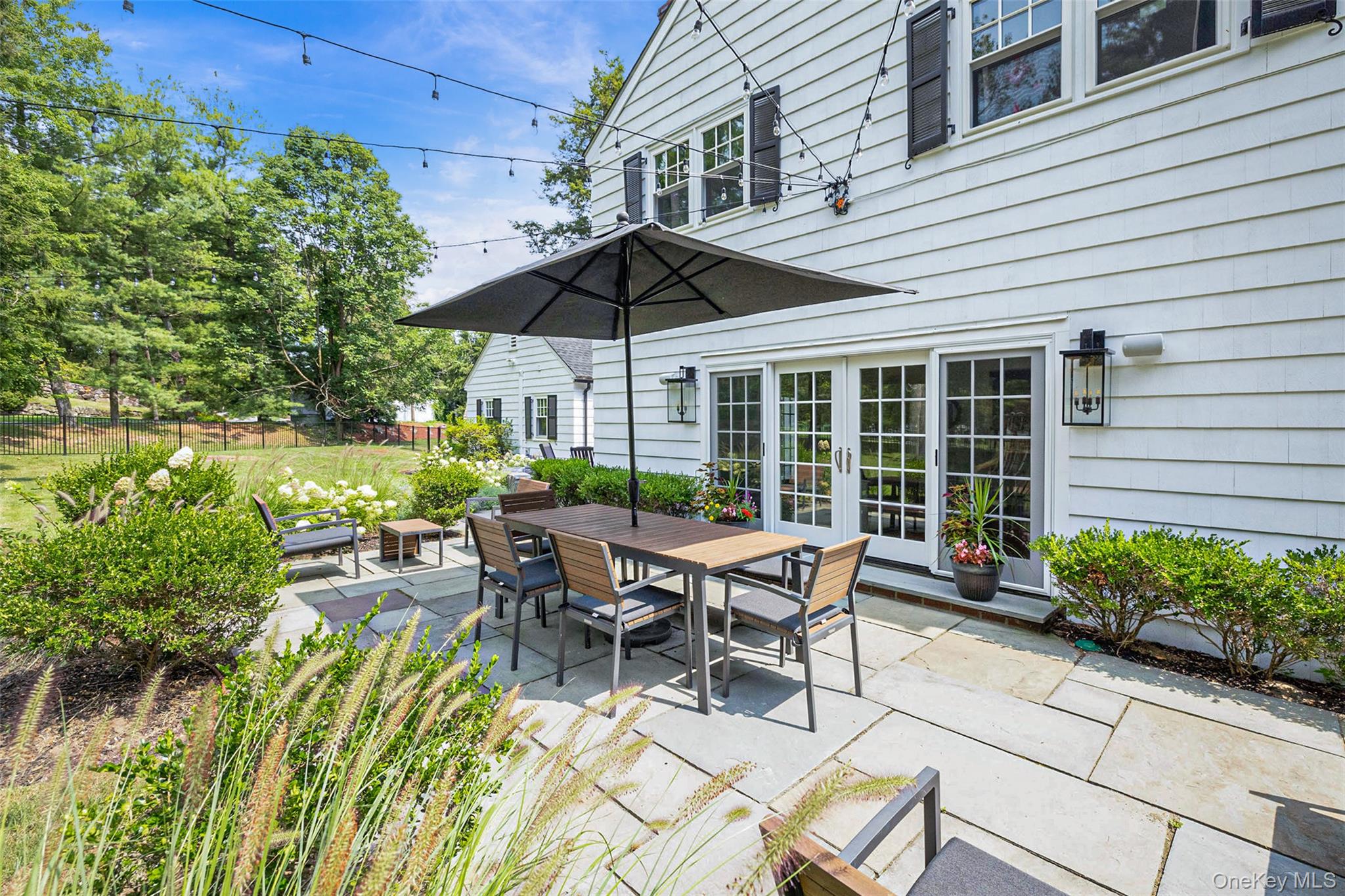 18 Lakeside Drive Rye, NY 10580 - Photo 38 of 43 a view of a patio with table and chairs under an umbrella