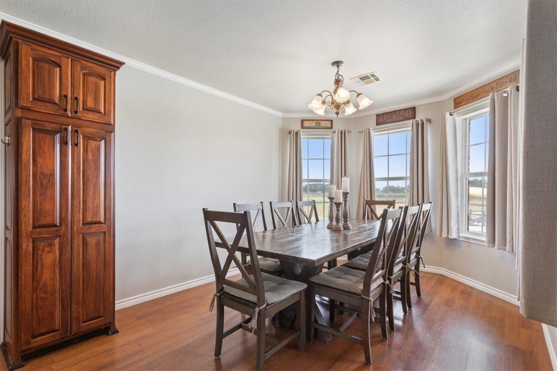 1045 Shiloh Trail China Spring, TX 76633 - Photo 11 of 35 a view of a dining room with furniture window and wooden floor
