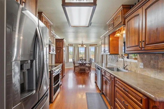a stove top oven sitting inside of a kitchen and granite counter tops