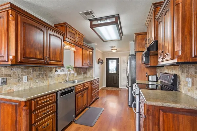 a kitchen with granite countertop a sink and a wooden cabinets