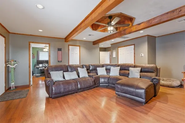 a living room with furniture a window and a flat screen tv
