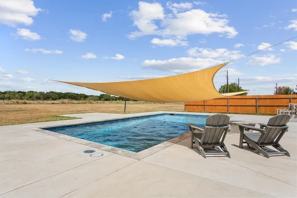 a view of a swimming pool and an outdoor seating