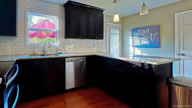 a kitchen with a sink and a wooden floor